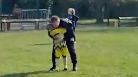 Dad embraces son on football pitch after first goal since cancer