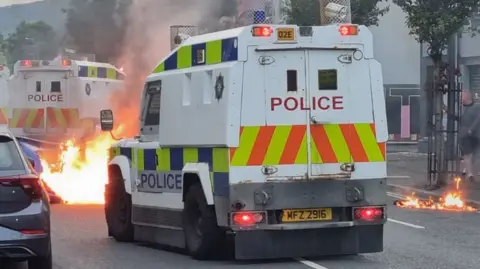 Police landrover in front of a fire