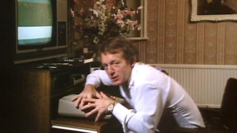 Paul Daniels leaning over his computer keyboard