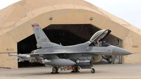 A pilot sits in a US F16 jet fighter at the al-Asad Air Base, west the capital Baghdad, as soldiers begin to begin their journey home out of Iraq, on November 1, 2011. 