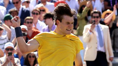 Jack Draper jumps into the air after beating Carlos Alcaraz at Queen's