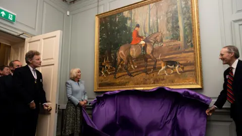 National Horse Racing Museum  Queen Camilla unveiling a picture in Palace House during a visit to the National Horseracing Museum in June 2023