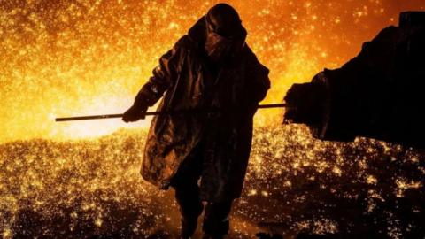 A steelworker tapping the blast furnace