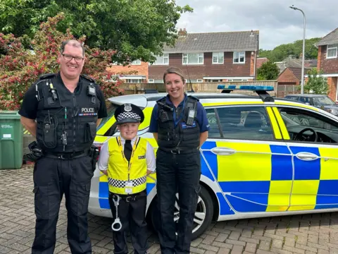 Finley between two police officers