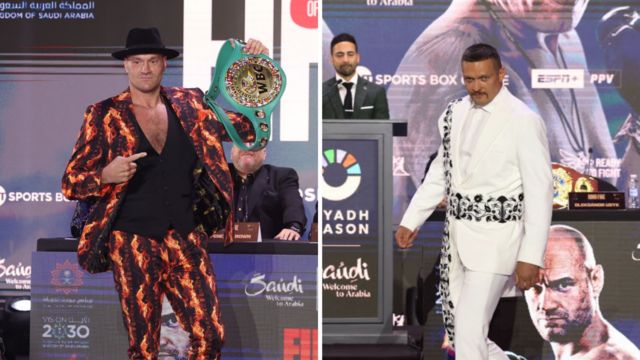 Tyson Fury in a flame suit and Oleksandr Usyk in a white suit