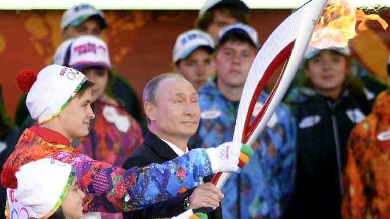 Vladimir Putin handles the Olympic torch, 6 Oct