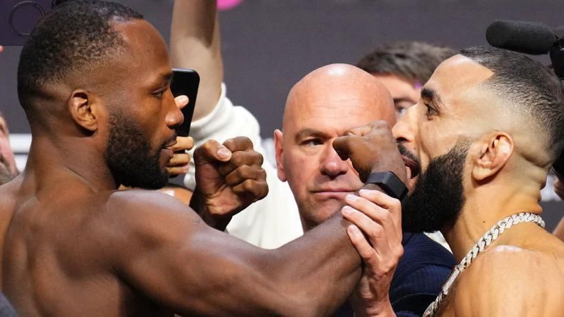 Leon Edwards faces off with Belal Muhammad with his fist out 