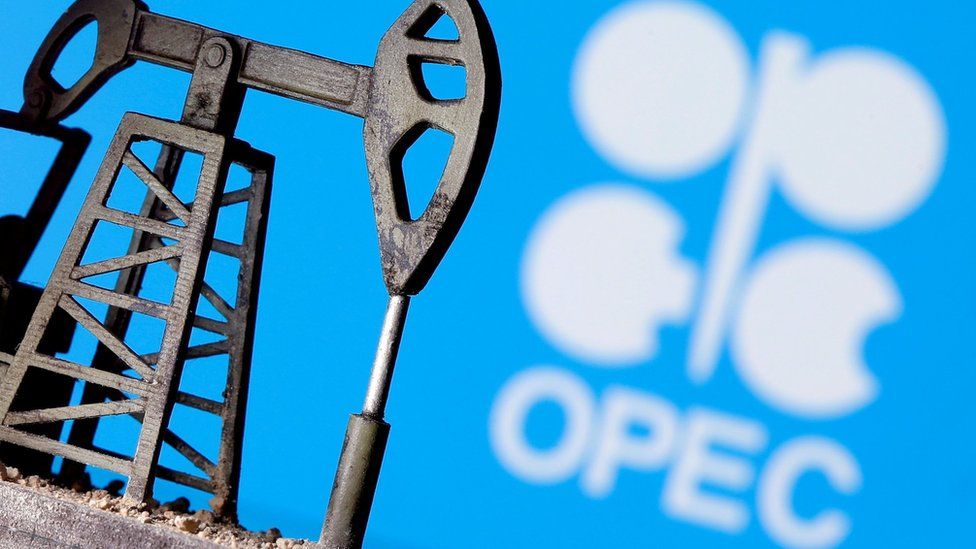 A 3D-printed oil pump jack is seen in front of the Opec logo (14 April 2020)