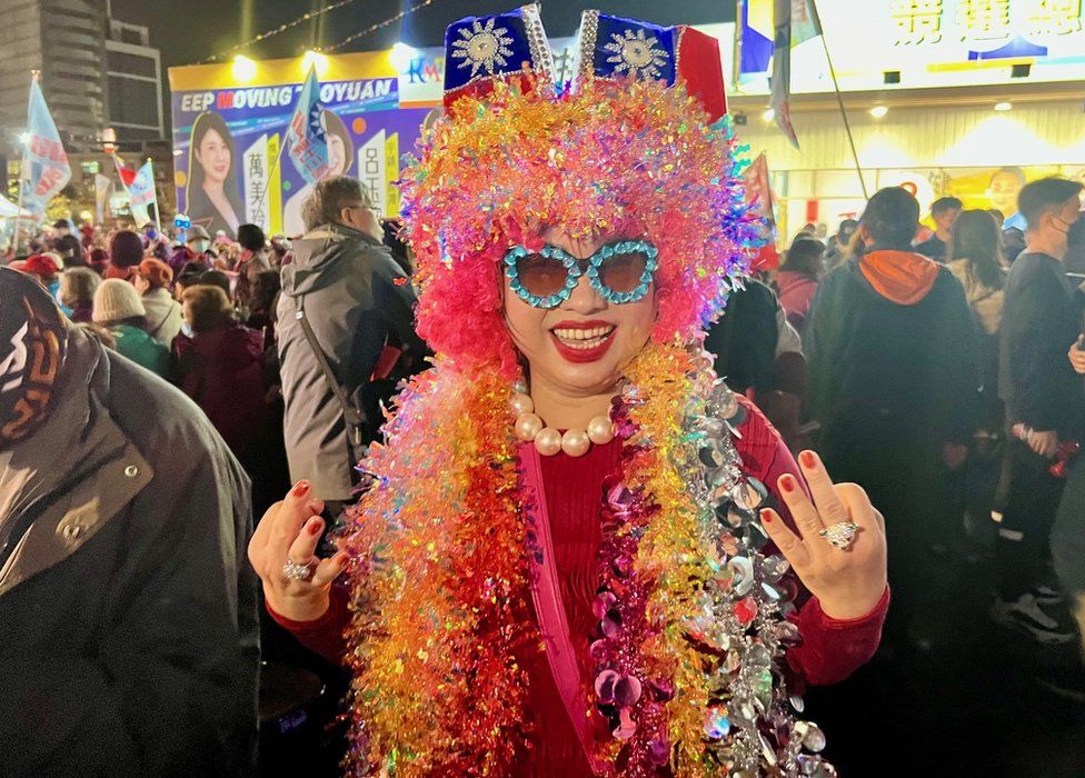 A woman dressed in tinsel and Christmas lights at the KMT rally