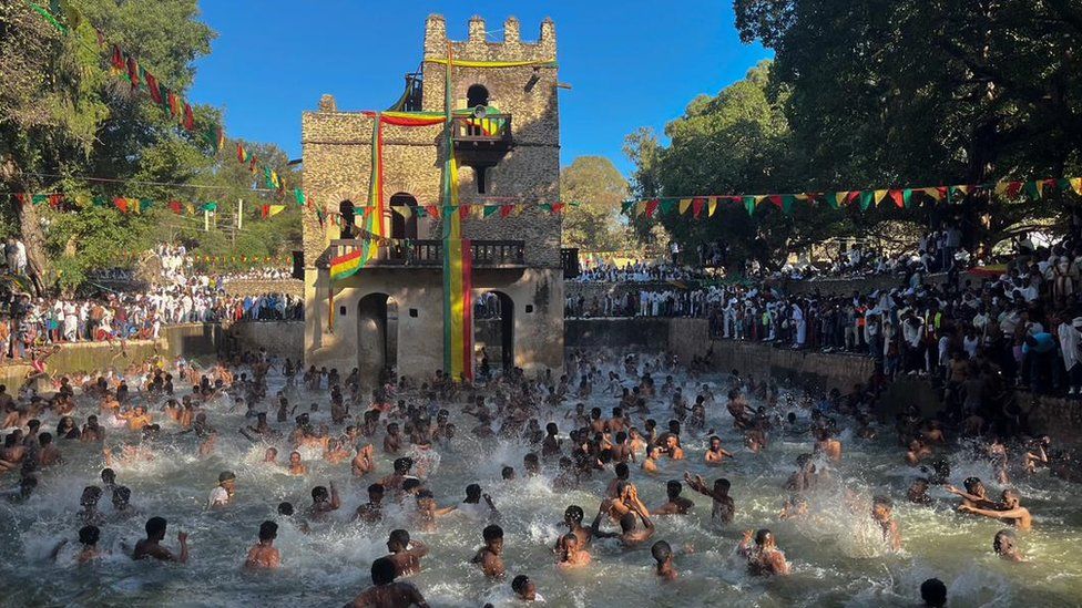 Attendees get baptised in a huge outdoor pool