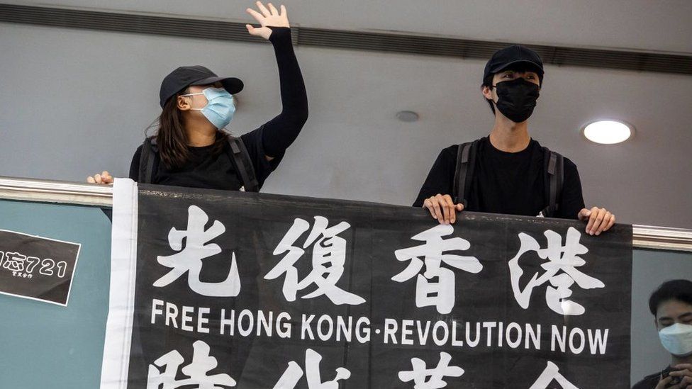 Pro-democracy demonstrators with a banner 'Free Hong Kong'