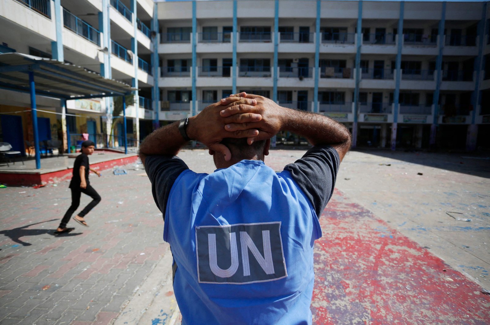 A U.N. volunteer stands in the yard of a U.N.-run school in the refugee camp of al-Maghazi in the central Gaza Strip, a day after at least six people were killed in a reported Israeli strike, Palestine, Oct. 18, 2023. (AFP Photo)