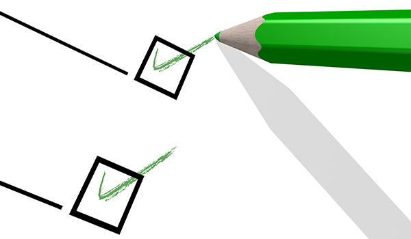 A green pencil checking off boxes