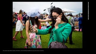 Two women take selfies Tuesday, November 3, while attending the Melbourne Cup horse races in Australia.
 