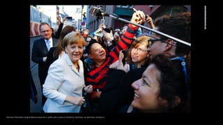 German Chancellor Angela Merkel poses for a selfie with a man in Frankfurt, Germany, on Saturday, October 3.
 