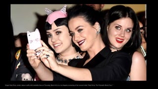 Singer Katy Perry, center, takes a selfie with lookalike fans on Thursday, March 26, at a Los Angeles screening of her concert video "Katy Perry: The Prismatic World Tour."
 