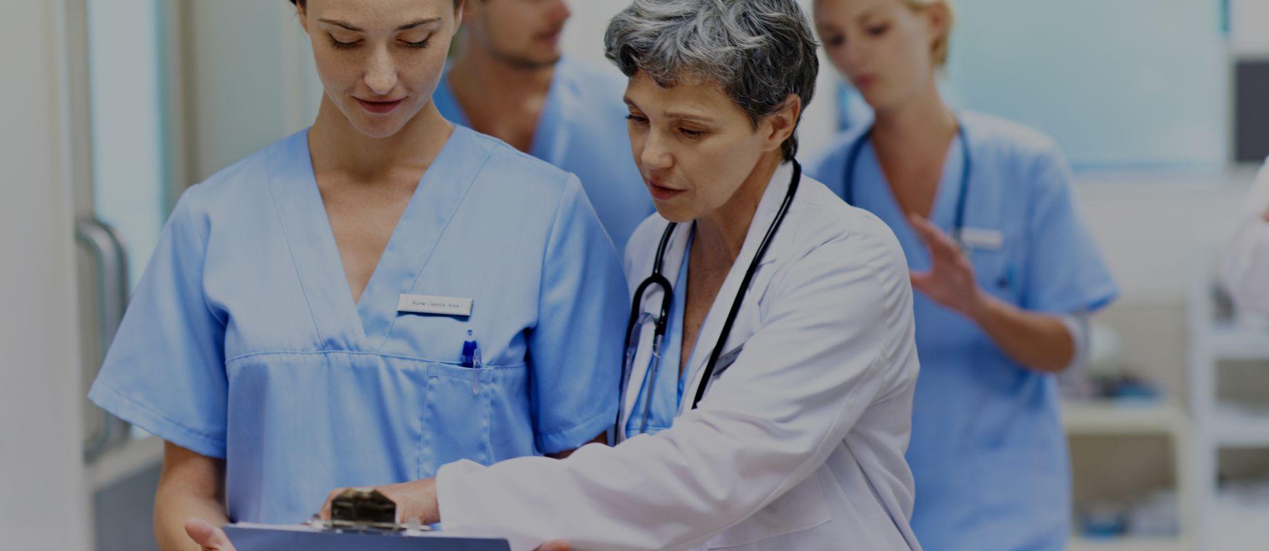 A doctor and a nurse looking at a screen together