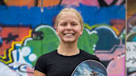 Heili Sirviö smiles with a skateboard in Tampere, Finland. 