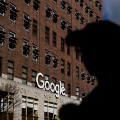 Googlen konttori, jonka edustalla ihmisen siluetti.