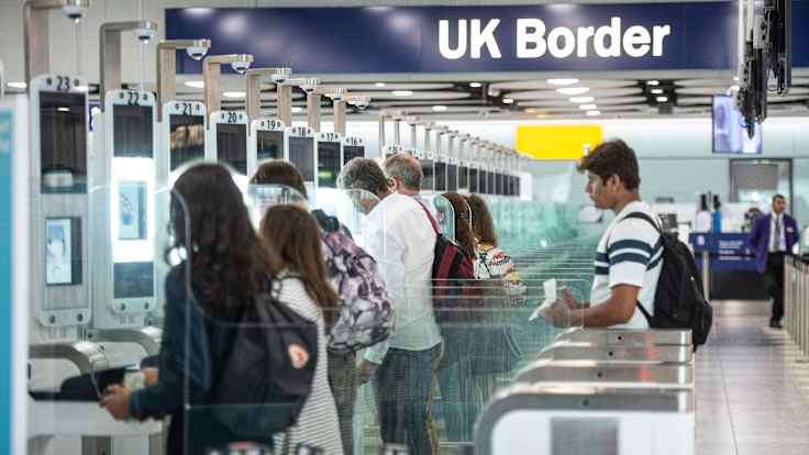 People in a passport control queue at London's Heathrow Airport. 