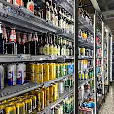 A store shelf full of beer.