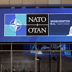 Nato summit sign on the wall of the building.