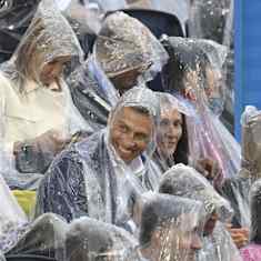 Finnish President Alexander Stubb in a poncho as rain falls.