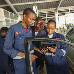  Kenyan auto mechanic students in blue overalls. 