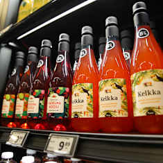 8% alcohol bottles on the grocery store shelf.