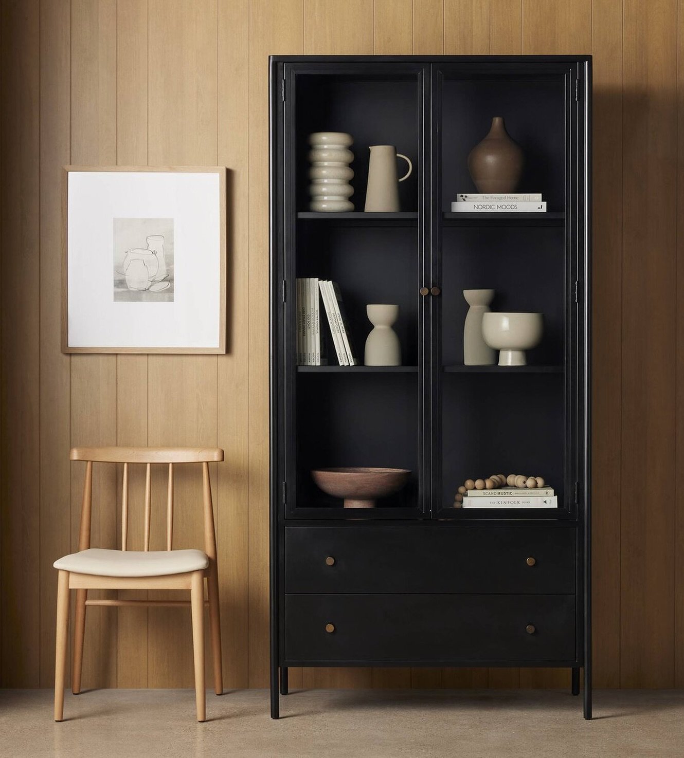 Ronald Cabinet | 
Bring a softened industrial look to the office, dining, or living room with spacious cabinetry made from black-finished iron featuring bronzed iron hardware fora modern touch. Glass-front doors allow endless storage and styling opti