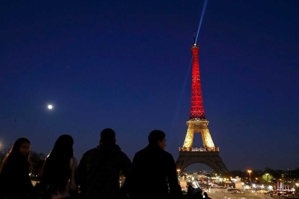 The Eiffel Tower is seen with the black, yellow and red colours of the Belgian flag in tribute to the victims of today's Brussels bomb attacks in Paris
