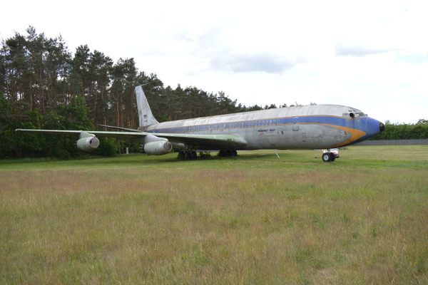 Retirement for this 707 means being parked beside a forest.