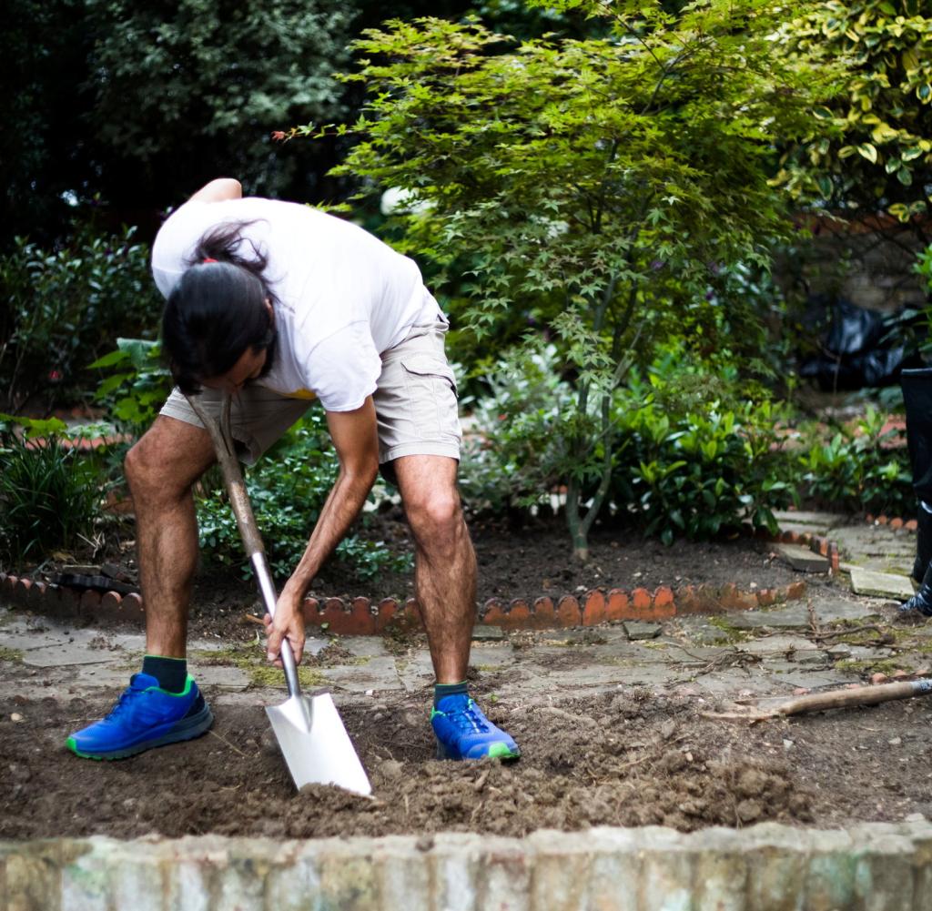 Man working in field digging mud / soil