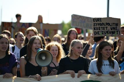 Fridays for Future: Participants hold up placards and shout slogans as they attend a climate protest organised by the Fridays for Future movement in front of the Reichstag building and the Chancellery in Berlin, Germany on September 20, 2024. (Photo by Tobias SCHWARZ / AFP) (Photo by TOBIAS SCHWARZ/AFP via Getty Images)