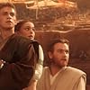 Just as their fate seems sealed, Anakin Skywalker (actor Hayden Christensen), Padmé Amidala (actress Natalie Portman), and Obi-Wan-Kenobi (actor Ewan McGregor) look up to see the Geonosis arena filled with Jedi rescuers.