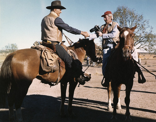 John Wayne and photographer David Sutton on the set of "Chisum"