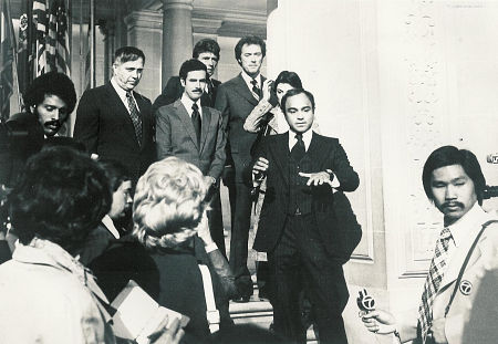 Going from left to right - lower left corner reporters (extras) unknown; upper left corner, African-American extra reporter unknown; John Crawford; Bradford Dillman; Harry Guardino; Clint Eastwood; Tyne Daley (behind Nick Pellegrino); Nick Pellegrino; Asian far right corner unknown 