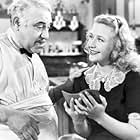 Henry Armetta and Priscilla Lane in Dust Be My Destiny (1939)