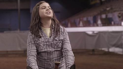 A group of rodeo trick-riders recruits a young girl to join them.