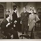 George Sanders, Sally Gray, Carl Jaffe, and Ralph Truman in The Saint in London (1939)
