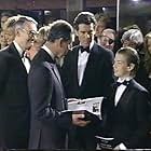 Pierce Brosnan, Sean Brosnan, King Charles III, and Michael G. Wilson in 007: The Return (1995)