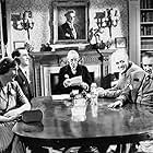 George Cole, Fay Compton, Guy Middleton, and Alastair Sim in Laughter in Paradise (1951)