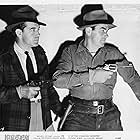 John Crawford and Anthony Warde in Dangers of the Canadian Mounted (1948)