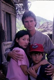 Richard Dean Anderson, Joan Chen, and Bryan Price in MacGyver (1985)