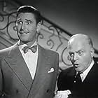 Errol Flynn and Grant Mitchell in Footsteps in the Dark (1941)