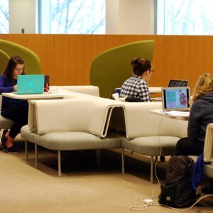 Students studying with laptops on soft seating