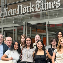 photo of posing in front of New York Times building