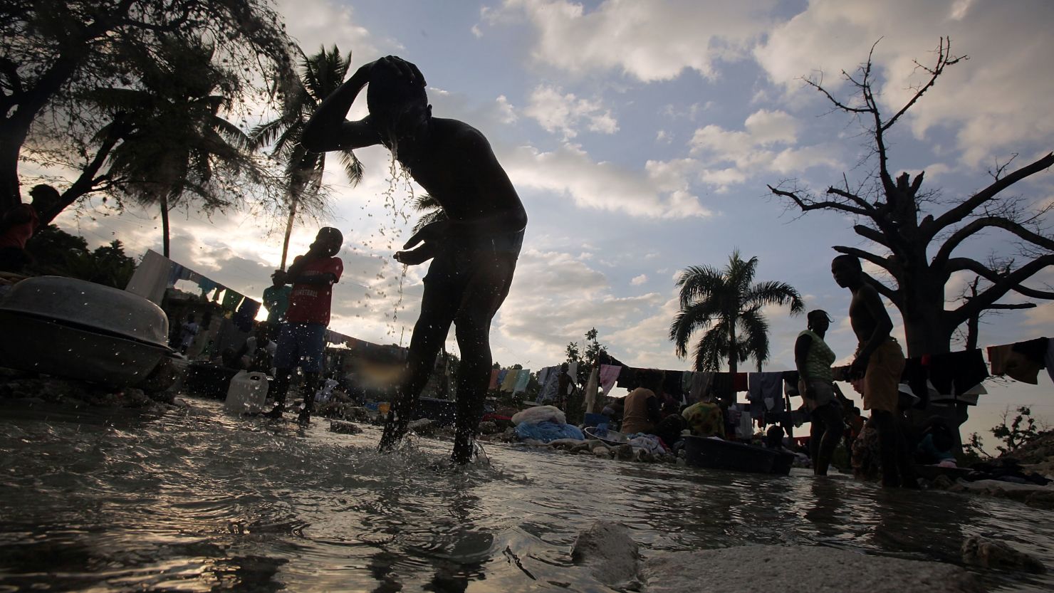 People bathe in a river in Port-au-Prince in January 2012. Cholera, though not indigenous to Haiti, remains rampant there.