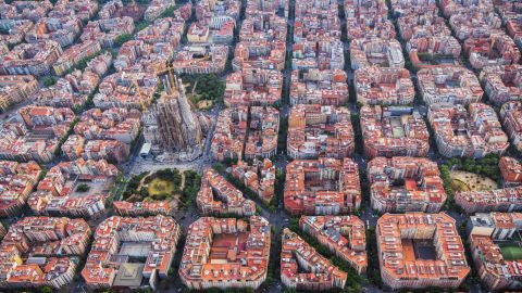 Aerial view of Barcelona Eixample residencial district and famous basilica, Spain. Late afternoon light