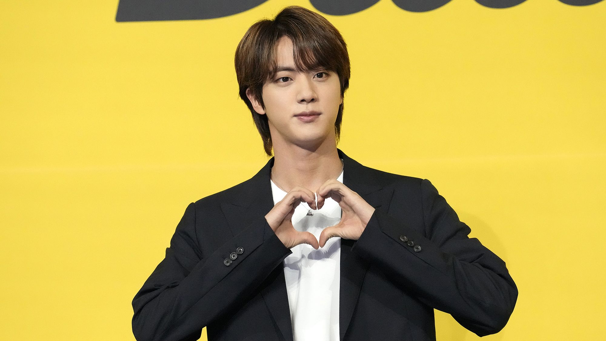 Jin, a member of South Korean K-pop band BTS poses for photographers ahead of a press conference to introduce their new single "Butter" in Seoul, South Korea, Friday, May 21, 2021. (AP Photo/Lee Jin-man)